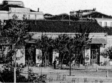 Το Καφενείον &quot;Νέος Κόσμος&quot; στην ανατολική πλευρά της Κεντρικής πλατείας. Λεπτομέρεια φωτογραφίας από επιστολικό δελτάριο του Στ. Στουρνάρα, ταχυδρομημένο τον Μάιο του 1909