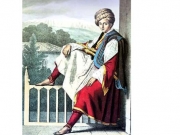 Un Page de Veli, pasha de Thessalie  (Ένας νεαρός υπηρέτης του Βελή πασά της Θεσσαλίας). Πίσω διακρίνεται τμήμα του παλατιού  του Βελή πασά στον Τύρναβο και στο βάθος  ο χιονοσκέπαστος Όλυμπος.  Χρωμολιθογραφία του Lois Dupre. 1819